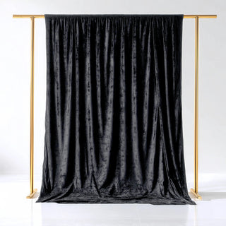 Black velvet backdrop with gold stand for photography.