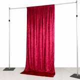 Red velvet backdrop on a metal frame for photography or events