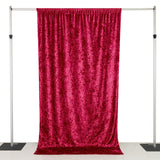 Pink velvet backdrop fabric hanging on a frame for photography.
