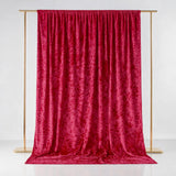 Red velvet backdrop draped elegantly on a gold frame.