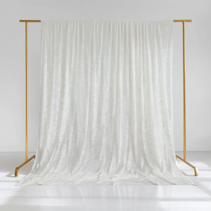 White velvet backdrop draped on a gold stand for photography