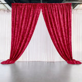 Red velvet curtains draped elegantly in a studio setting