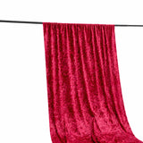 Red velvet curtain draped on a rod against a white background