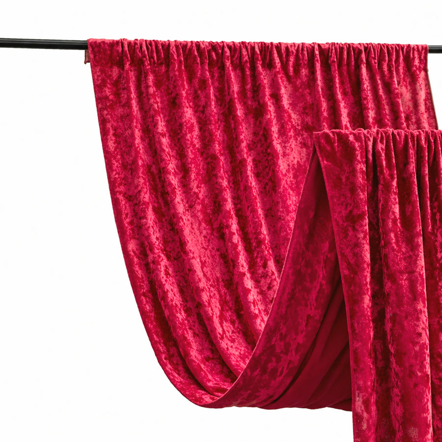 Red velvet drapery fabric hanging on a rod.
