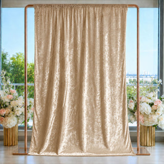 Champagne gold velvet curtain backdrop with floral arrangements and copper frame