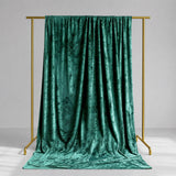 Emerald green velvet draped backdrop on gold frame studio stand