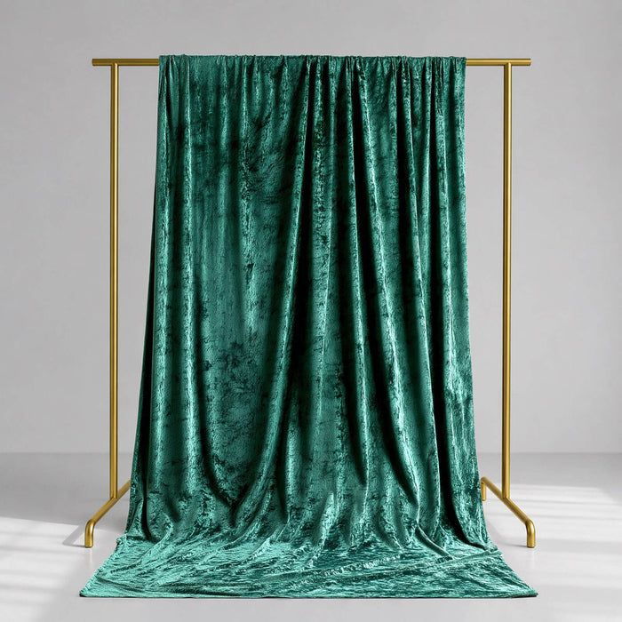 Emerald green velvet draped backdrop on gold frame studio stand