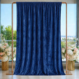 Navy blue velvet curtain backdrop with gold frame and floral arrangements