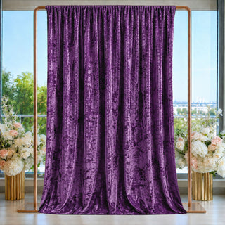Purple velvet curtain backdrop with floral arrangements and gold frame