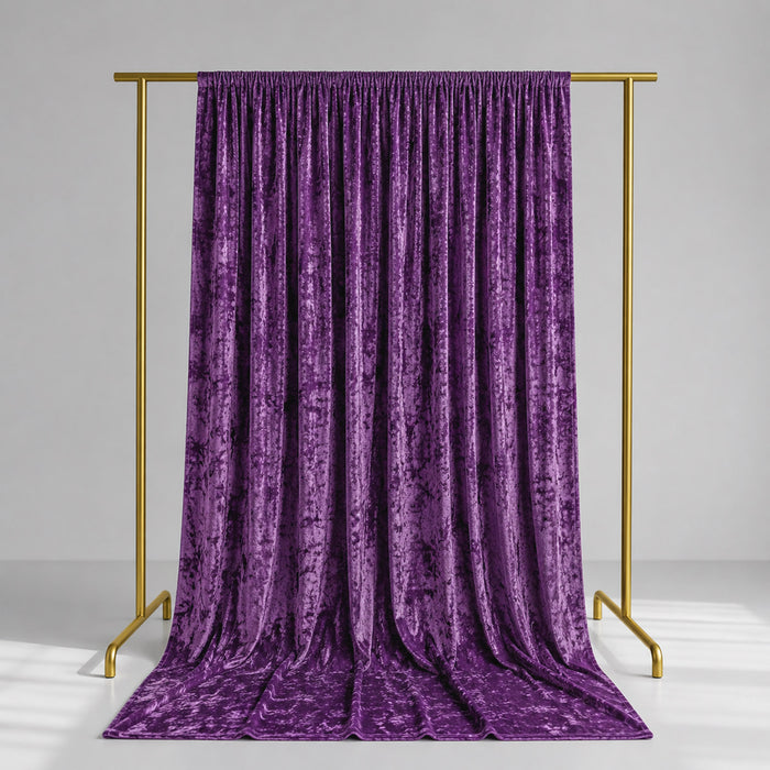 Purple velvet curtain on gold clothing rack against a gray studio background