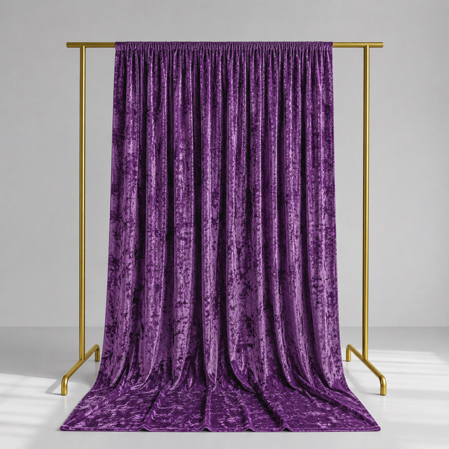 Purple velvet curtain on gold clothing rack against a gray studio background
