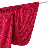 Red textured fabric draped elegantly on a white backdrop.