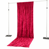 Red velvet backdrop draped on a stand for photography or events