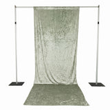 Portable silver photography backdrop stand with draped velvet curtain and floor sweep