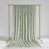 Sage green velvet curtains on gold clothing rack, elegant studio backdrop
