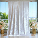 White satin wedding backdrop curtain on rose gold frame with floral arrangements