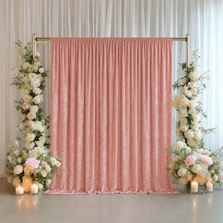 Pink wedding backdrop with floral arrangements and candles