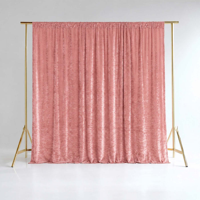 Pink velvet curtain on gold backdrop stand in a studio setting