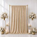 Elegant gold wedding backdrop with champagne curtain and white floral arrangements