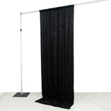 Black velvet photography curtain backdrop on adjustable stand