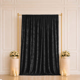Black velvet backdrop curtain with gold stand and floral pedestal decorations