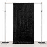 Black photography backdrop stand with adjustable support poles and curtain drape