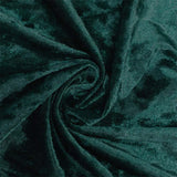 Dark green velvet fabric close-up with soft swirling folds and texture#whtbkgd