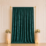 Emerald velvet backdrop with gold frame and floral candle decor