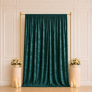 Emerald velvet backdrop with gold frame and floral candle decor