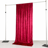 Adjustable pipe and drape backdrop with red velvet curtain on stand