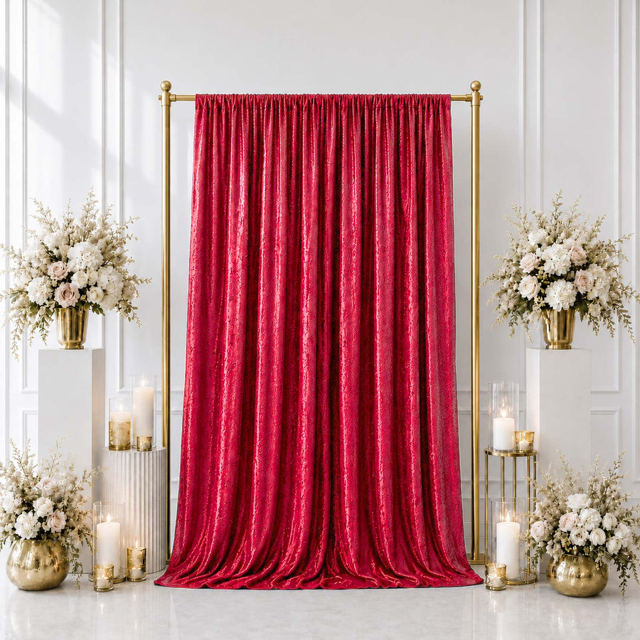 Elegant red velvet wedding backdrop with gold stands and floral arrangements