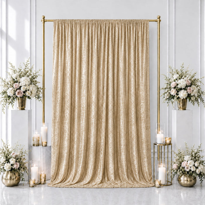 Elegant gold wedding backdrop with beige drapes, floral arrangements, and candles
