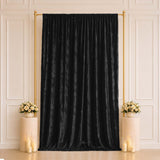 Black velvet backdrop curtain with gold stand and floral decor for events