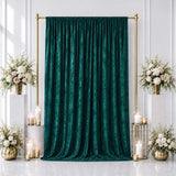 Elegant emerald green velvet backdrop with gold floral wedding decor and candles