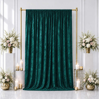 Elegant emerald green velvet backdrop with gold floral wedding decor and candles