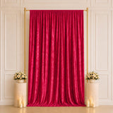 Elegant red velvet curtain backdrop with gold stand and floral arrangements