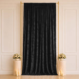 Elegant black velvet curtain backdrop with gold frame and floral decor