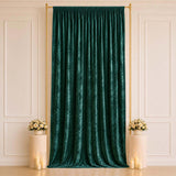 Emerald velvet curtain backdrop with gold stand and floral decor