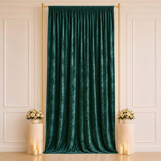 Emerald velvet curtain backdrop with gold stand and floral decor