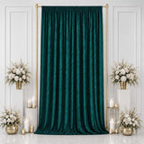 Emerald green velvet backdrop with gold frame and white floral arrangements