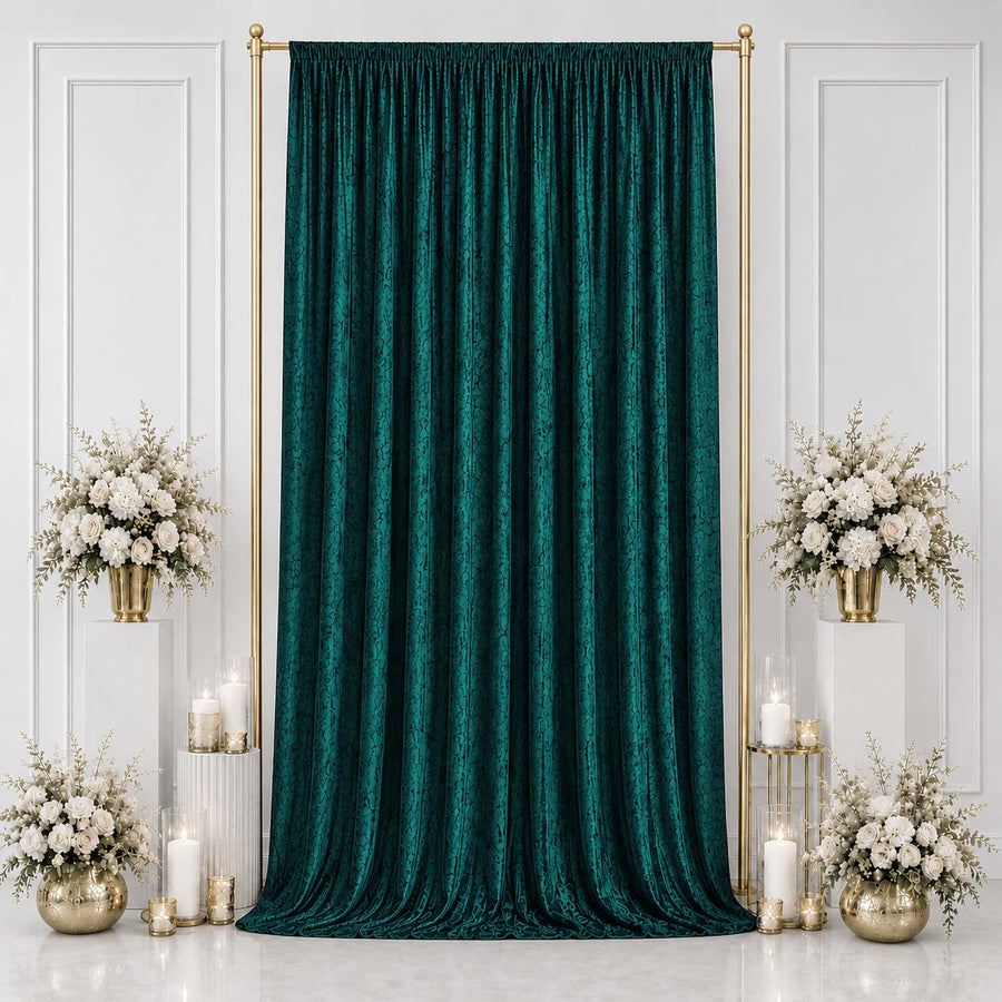 Emerald green velvet backdrop with gold frame and white floral arrangements