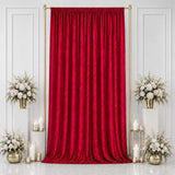 Red velvet curtain backdrop with gold stand and white floral arrangements
