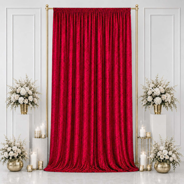 Red velvet curtain backdrop with gold stand and white floral arrangements