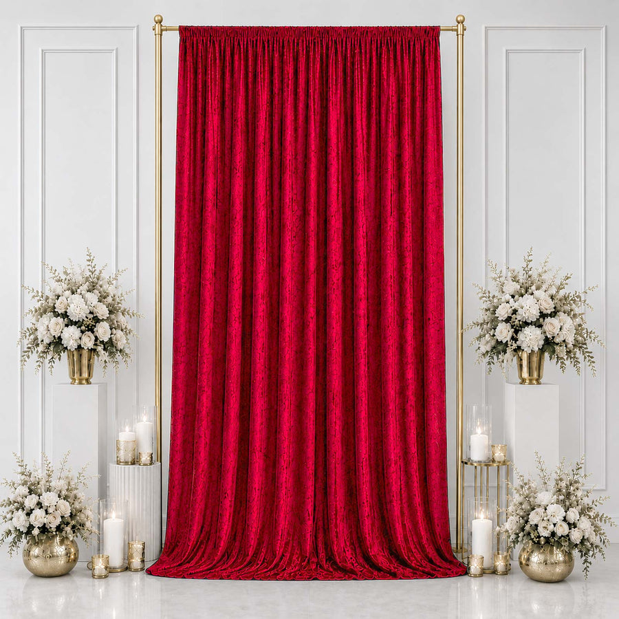 Red velvet curtain backdrop with gold stand and white floral arrangements