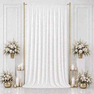 Elegant white wedding backdrop with gold accents and floral arrangements