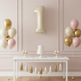 Gold number 1 balloon at a birthday party table with cake and balloons.