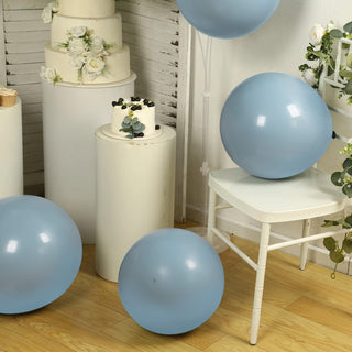 Blue balloons on a wooden floor with a cake and decorative elements.