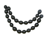 Black bead necklace with oval-shaped beads arranged in a layered design. #whtbkgd