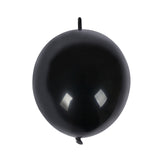 Black helium balloon on a plain background