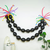 Black balloon garland with colorful accents for festive decorations.